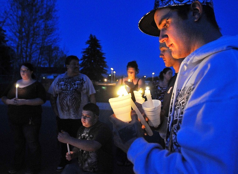 Howard Jones is joined by other patrons of Club Dungeon, a underage nightclub in downtown Kalispell, while lighting candles Tuesday in memory of Wesley Collins, who was murdered in his home last week. The group of about 20 people walked and rode in cars to Collins&#146; home, where they held a vigil.