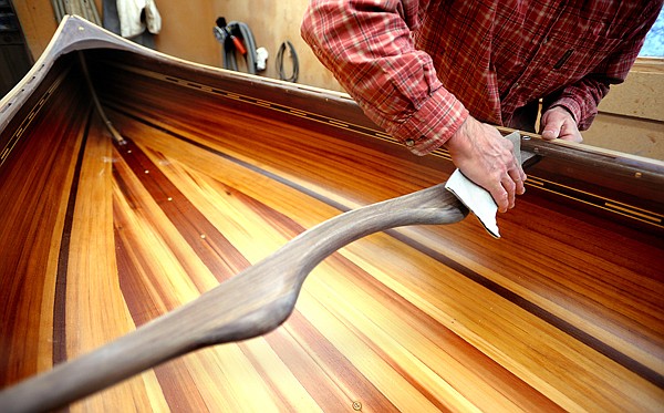 Steve Morley works on a 16 foot guide canoe on Wednesday, April 14. Morley said this is the most common boat they build. This particular boat is heading to a customer in Pennsylvania.