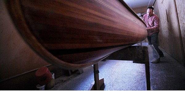 Steve Morley works on a 16 foot guide canoe on Wednesday, April 14. Morley said this is the most common boat they build. This particular boat is heading to a customer in Pennsylvania.