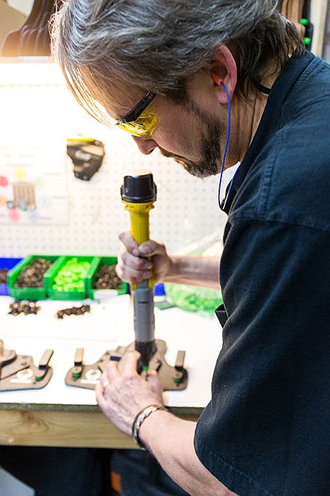 &lt;p&gt;Jeff Tucker, an assembler at Tedder Industries, fastens holster parts together using a battery-operated screwdriver during his shift.&lt;/p&gt;