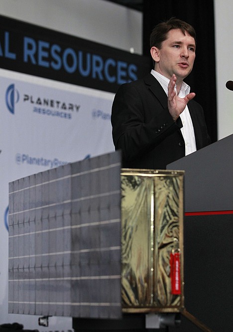 <p>AP Photo/Elaine Thompson Planetary Resources Inc. president and chief engineer Chris Lewicki speaks behind a full-size prototype model of a low-orbit spacecraft at a news conference announcing a plan to mine nearby asteroids Tuesday in Seattle.</p>