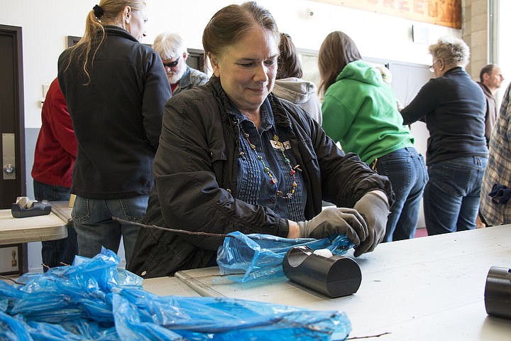 &lt;p&gt;Kim Cheeley labels seedlings at the Kootenai County Arbor Day Program. She met John Schwandt, co-chair of the Kootenai County Arbor Day Committee, when he came out to her house to measure a ponderosa pine tree. It turns out that her ponderosa is the biggest one in Coeur d&#146;Alene. Cheeley&#146;s granddaughter is in fourth grade at Bryan Elementary School and will be getting a seedling from Monday&#146;s efforts.&lt;/p&gt;