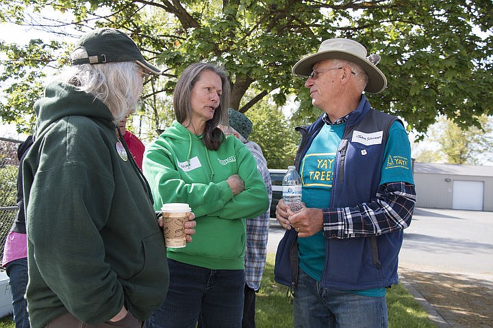 &lt;p&gt;John Schwandt talks with arborist Nina Eckburg and another volunteer at the Kootenai County Arbor Day Committee&#146;s tree bagging event Monday.&lt;/p&gt;