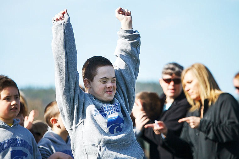 <p>Paul Salo throws his arms up in celebration after his second attempt in the tennis-ball throw Friday morning during the Special Olympics Montana Area Games at Legends Stadium.</p>