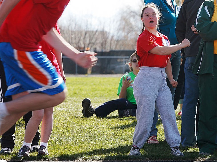 <p>Cedar Vance cheers on runners Friday morning during the Special Olympics.</p>