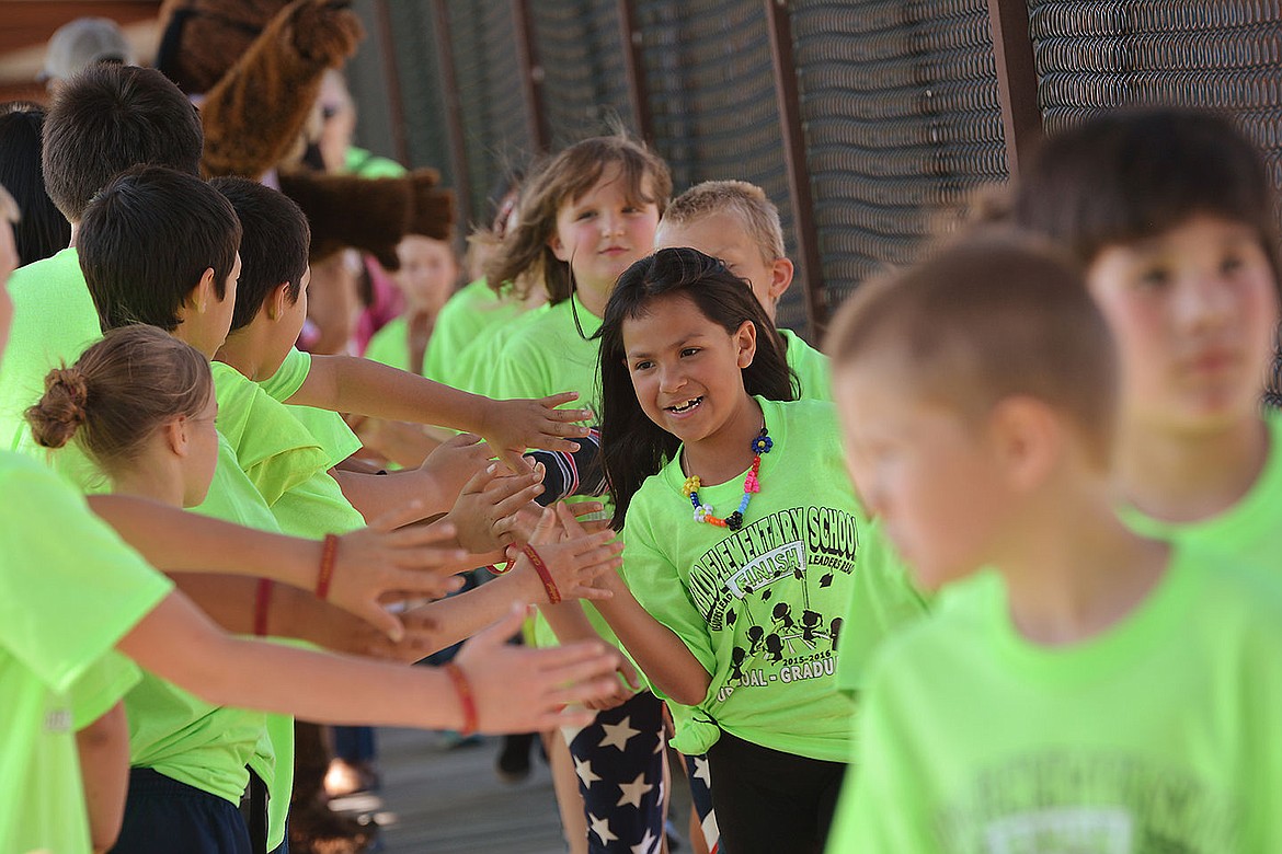 &lt;p&gt;Elliott Natz Lake County Leader Deja-May Little-Mary, 8, high-fives a line of third and fourth grade students during the Pablo Elemnetary parade.&lt;/p&gt;