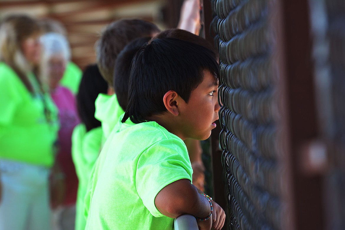 &lt;p&gt;Elliott Natz Lake County Leader Brandon Moultan, 8, looks over Highway 93 as cars drive underneath the bridge occasionally honking in support of the kids committment to graduate high school.&lt;/p&gt;