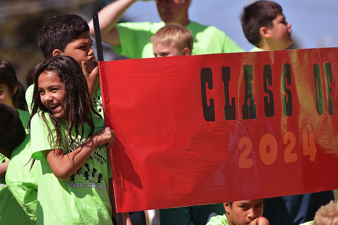 &lt;p&gt;Elliott Natz Lake County Leader Ino Brueggeman, 10, holds the banner with 2024, the year she and her fourth-grade classmates pledged to graduate from high school.&lt;/p&gt;