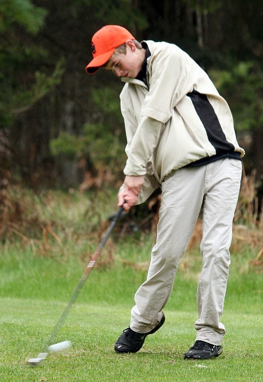 Jeff Revier of Plains hits the ball off the fairway with a one of his irons at Thompson Falls.