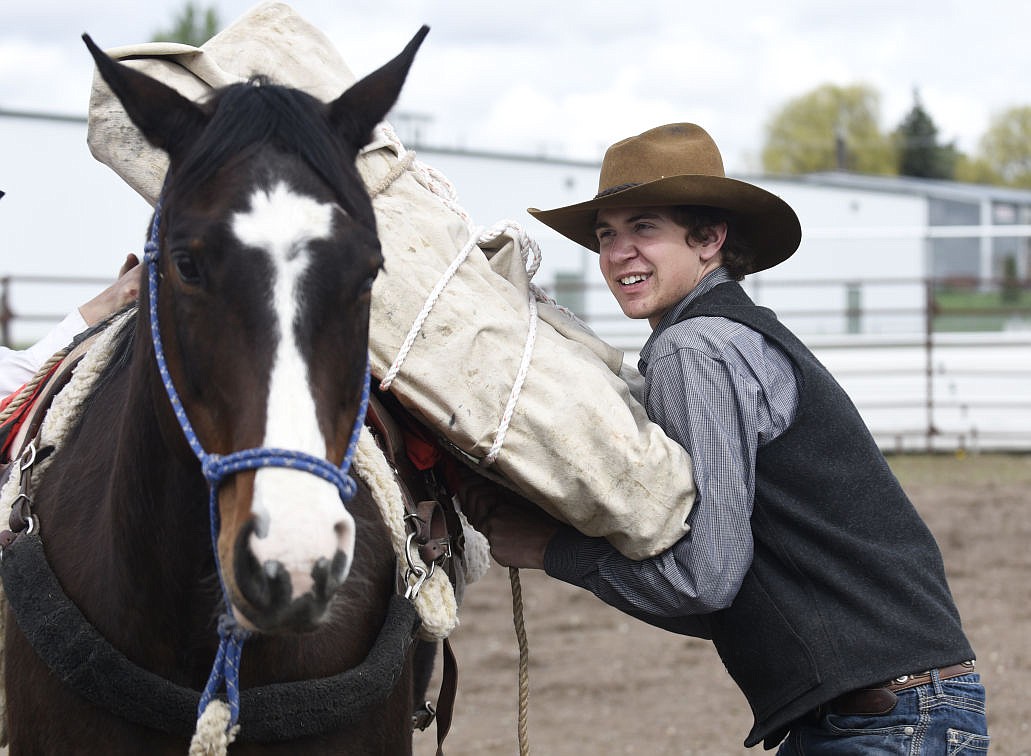 <p>Parker Cameron secures a mantie pack on Snoopy during the Northwest Montana Backcountry Horsemen 4-H packing clinic at the Flathead County Fairgrounds Saturday. (Aaric Bryan/Daily Inter Lake)</p>