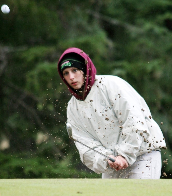 Shelby Berg, playing as the #5 golfer from St. Regis, chips her ball out of the bunker on hole #6 at Thompson Falls on Saturday.