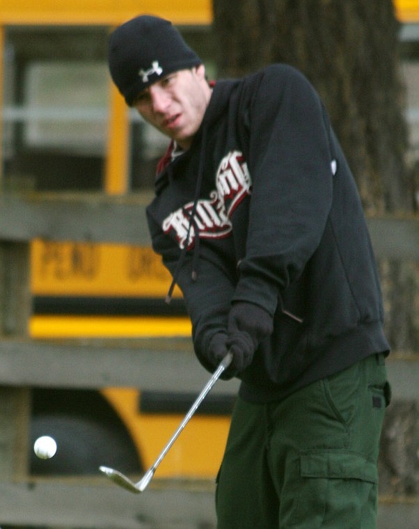 Shad Hotchkiss, playing as the #2 golfer from St. Regis chips a ball onto the ninth green at Thompson Falls on Saturday.