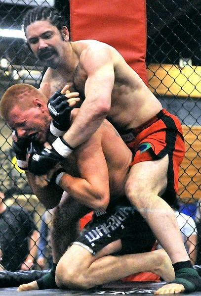 Kalispell's Chhimed Kunzang puts Polson's Cody Weaving into a headlock.