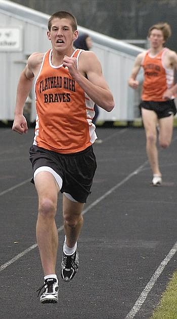 Flathead High School's Jesse Bennett eyes the finish line in the 1,600, with teammate Leif Castren trailing. Allison Money photo/Daily Inter Lake