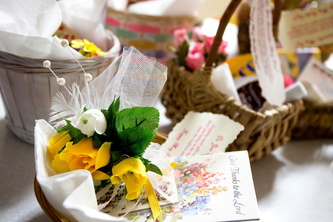&lt;p&gt;May baskets, full of flowers, inspirational poems, candy and small trinkets, rest on the kitchen counter of Penny Inglis' Coeur d'Alene home on Wednesday. Inglis began delivering baskets similar to these when she was a child, and has continued the tradition and included her extended family in the annual event.&lt;/p&gt;