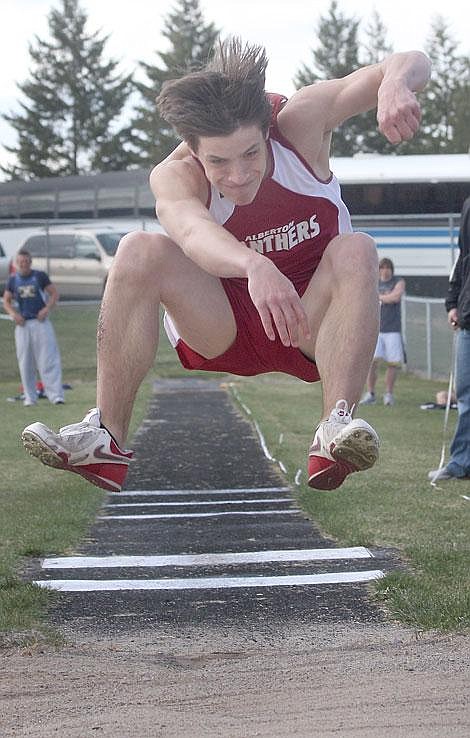 Photo by Aaric Bryan Alberton junior James Wemple soars through the air for the winning jump at the top 10 track meet last Tuesday.