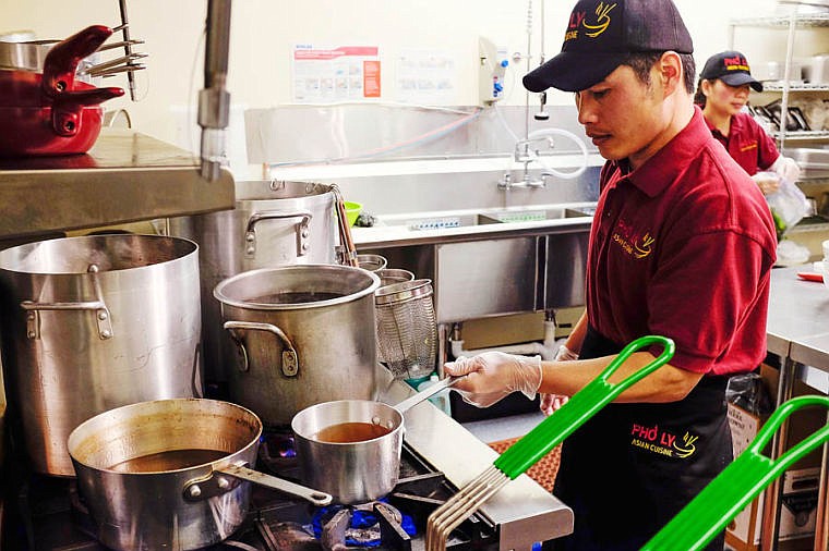 &lt;p&gt;Jon Ly fires up a pot of broth Wednesday afternoon at Pho Ly in Evergreen. Ly&#146;s wife, Jinnie, prepares jalapenos in the background.&lt;/p&gt;