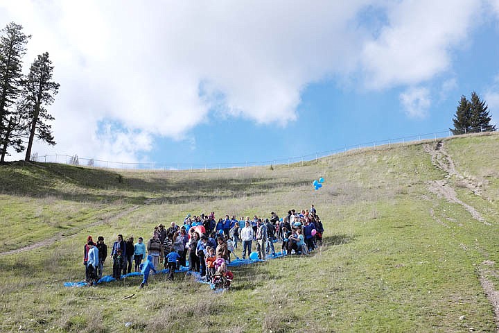 &lt;p&gt;Supporters of Child Abuse and Neglect Prevention Month form a human blue ribbon Wednesday afternoon on the hill at Lawrence Park in Kalispell. April 23, 2014 in Kalispell, Montana. (Patrick Cote/Daily Inter Lake)&lt;/p&gt;