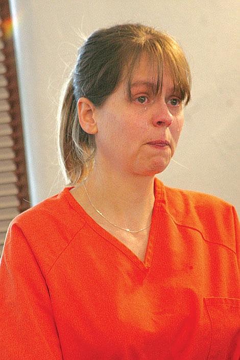 Photo by Nick Ianniello Sherri Renee Telnas starts to cry at her initial appearance in District Court in Superior Wednesday.