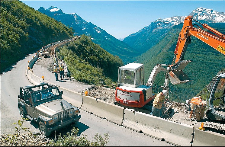 With One Lane under construction near Haystack Creek, tourists cruise past the work zone along Going-to-the-Sun Road in Glacier Park in summer 2004.  The $200 million reconstruction of the alpine highway is about halfway completed. Reconstruction work will continue through 2019.