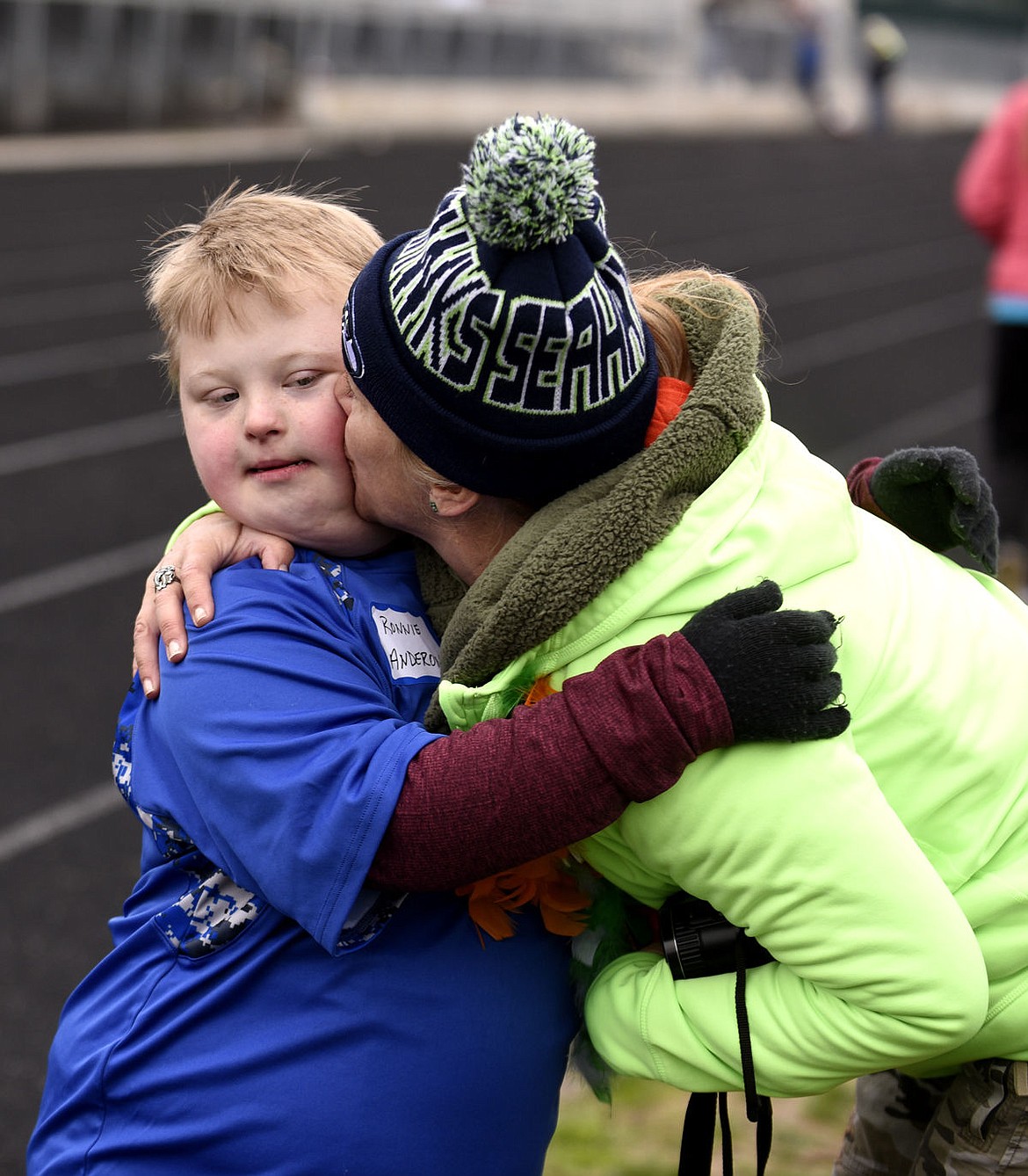 <p>Ronnie Anderson is kissed by his aunt Lynette Erickson after finishing a race at the Special Olympics Montana Glacier Area Games on Friday. (Aaric Bryan/Daily Inter Lake)</p>