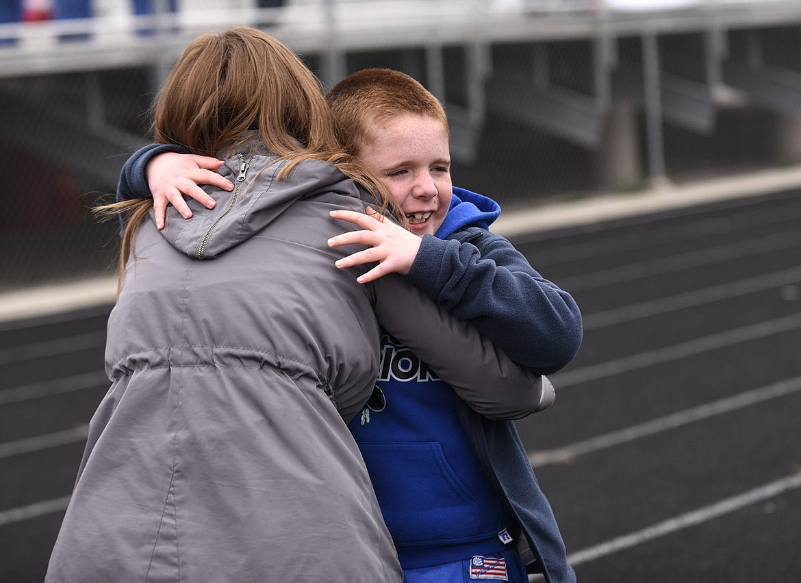 <p>West Valley Warrior Brady Streitmatter hugs his coach Molly Roe after finishing the 50-meter race during the Special Olympics Montana Glacier Area Games. (Aaric Bryan/Daily Inter Lake)</p>