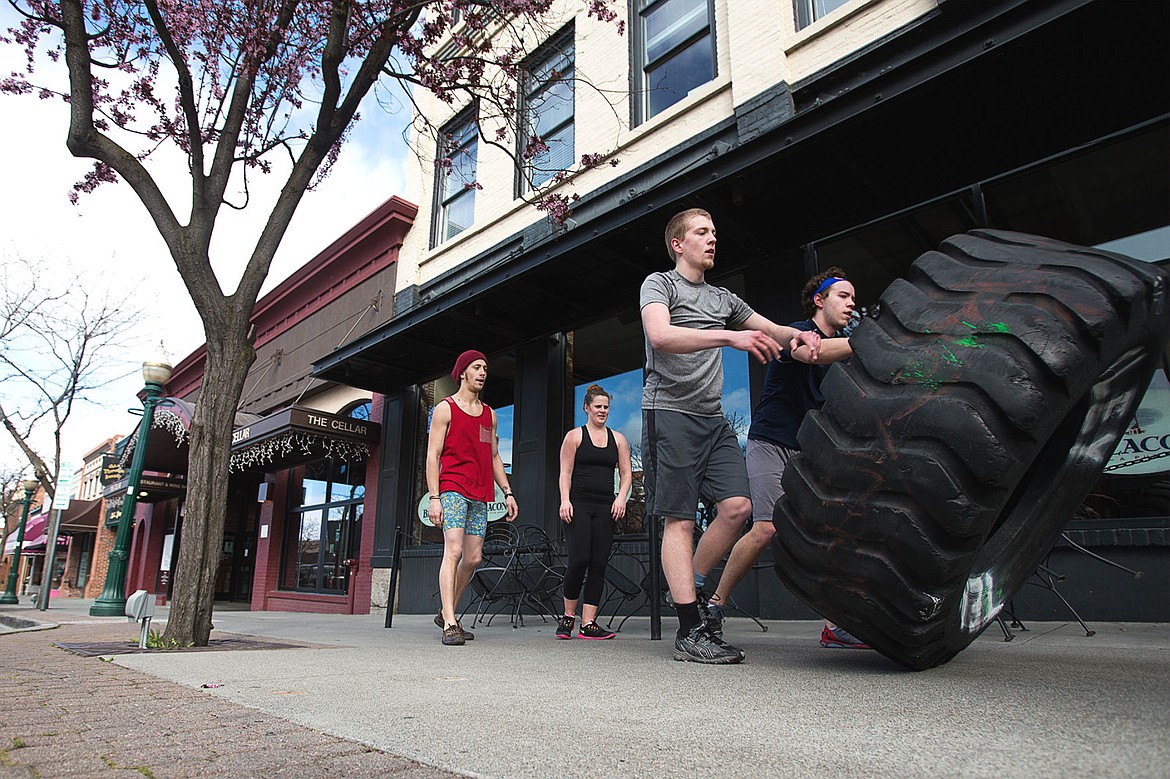 &lt;p&gt;Kyler Scott, left, and Steve Blee take part in rolling a tire down the sidewalk with Kyle Rutlley Fitness in downtown Coeur D&#146;Alene on Wednesday.&lt;/p&gt;