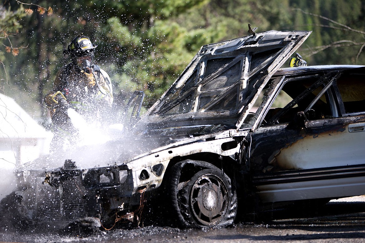 &lt;p&gt;A firefighter hoses down what was once a flaming car on an off ramp from I-90 onto Sherman Ave. Wednesday. The driver recalled smelling smoke and pulled over to unveil the flames underneath the hood. No injuries were reported.&lt;/p&gt;