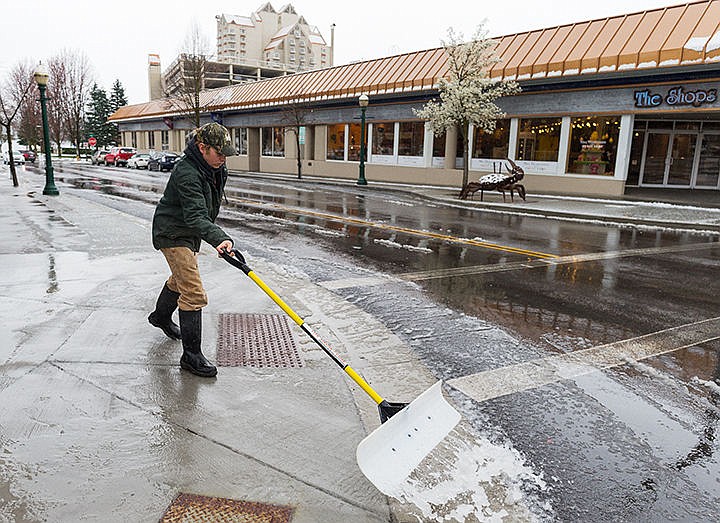 &lt;p&gt;Chris Bergmann shovels slushy snow from the sidewalk near the intersection of Third Street and Sherman Avenue Monday in Coeur d&#146;Alene.&lt;/p&gt;