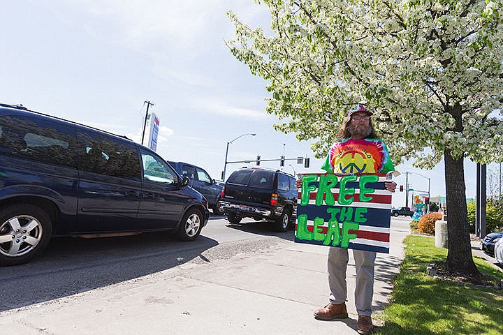 &lt;p&gt;Freeman Buckhanan, with the Coeur d&#146;Alene Cannabis Club, holds a sign on the sidewalk near the intersection of Appleway Avenue and U.S. 95 on Monday while another represenatitive with the group collected signatures for a petition to legalize marijuana in Idaho.&lt;/p&gt;