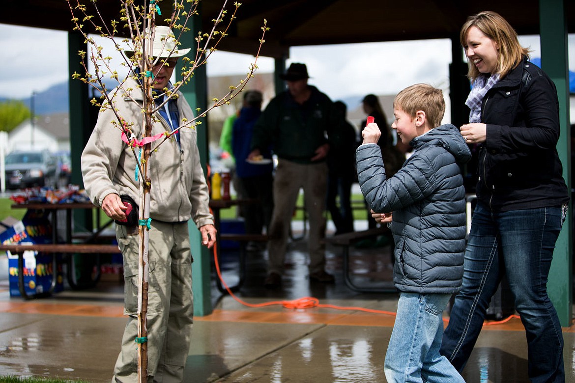 &lt;p&gt;Carter May, 9, holds up his winning raffle ticket and gets a closer look of his new brandy wine maple tree alongside mother, Tara May, at the Arbor Day Celebration.&lt;/p&gt;