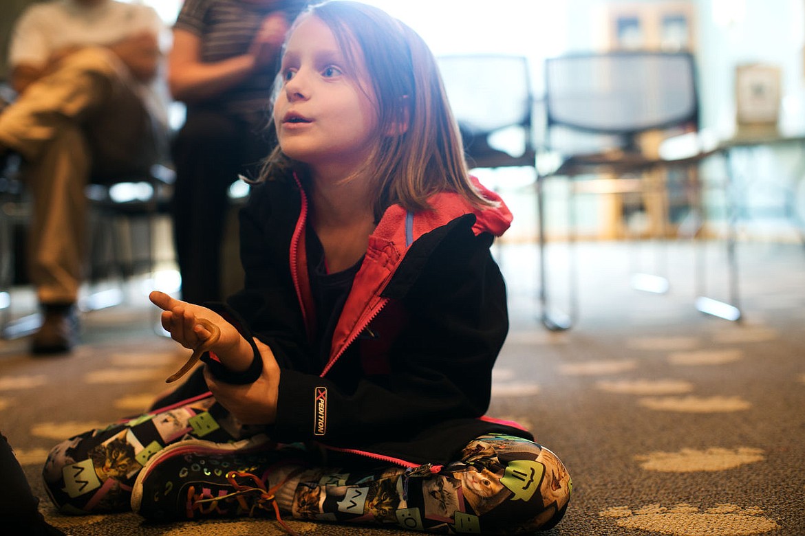 &lt;p&gt;Ellasynn Adams, 7, asks a question about the baby snake hanging out in her hand at the Coeur d&#146;Alene Library Wednesday. The Children&#146;s Arbor Day programs featured animals and interactive wildlife education.&lt;/p&gt;