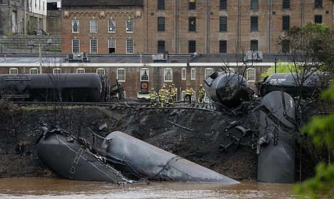 &lt;p&gt;Firefighters and rescue workers work along the tracks where several CSX tanker cars carrying crude oil derailed and caught fire along the James River near downtown in Lynchburg, Va., Wednesday. Nearby buildings were evacuated for a time, but officials said there were no injuries and the city on its website and Twitter said firefighters on the scene made the decision to let the fire burn out.&lt;/p&gt;