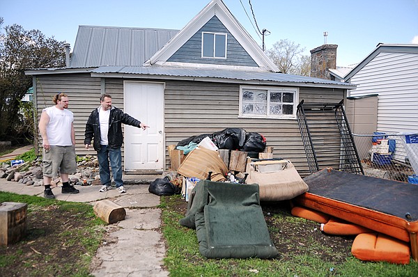 Tony Petero, right, shows his son, Paul Prince of Whitefish, the furniture that rents had kept on the roof and merely pushed off when they moved out.