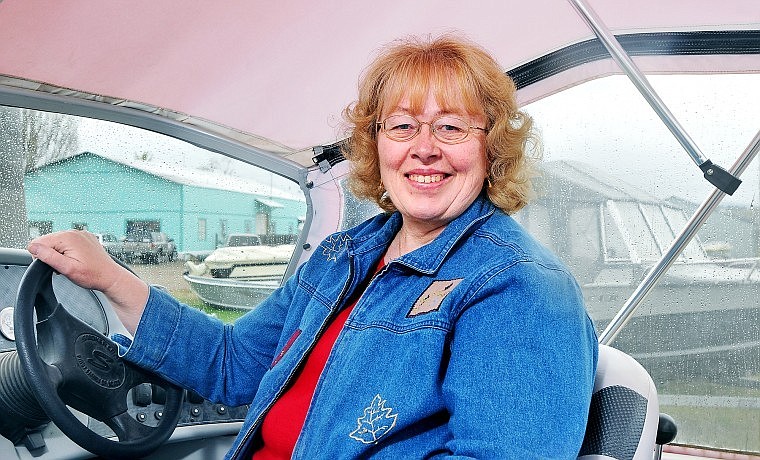 Pam Holmquist sits in the driver's seat of a boat at Rocky Mountain Marine, a business in Evergreen which she has owned for 32 years. She is running as a Republican for county commissioner.