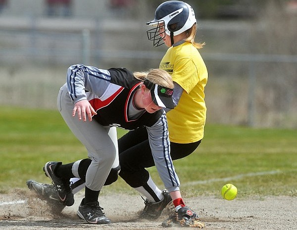 Kalispell Insty Print's Genny Burnham sneaks past Polson Smash's third basemen Peyton Anderson on a steal late in the game. Despite the play, Burnham was unable to score in the inning, giving Polson a 4-2 victory.