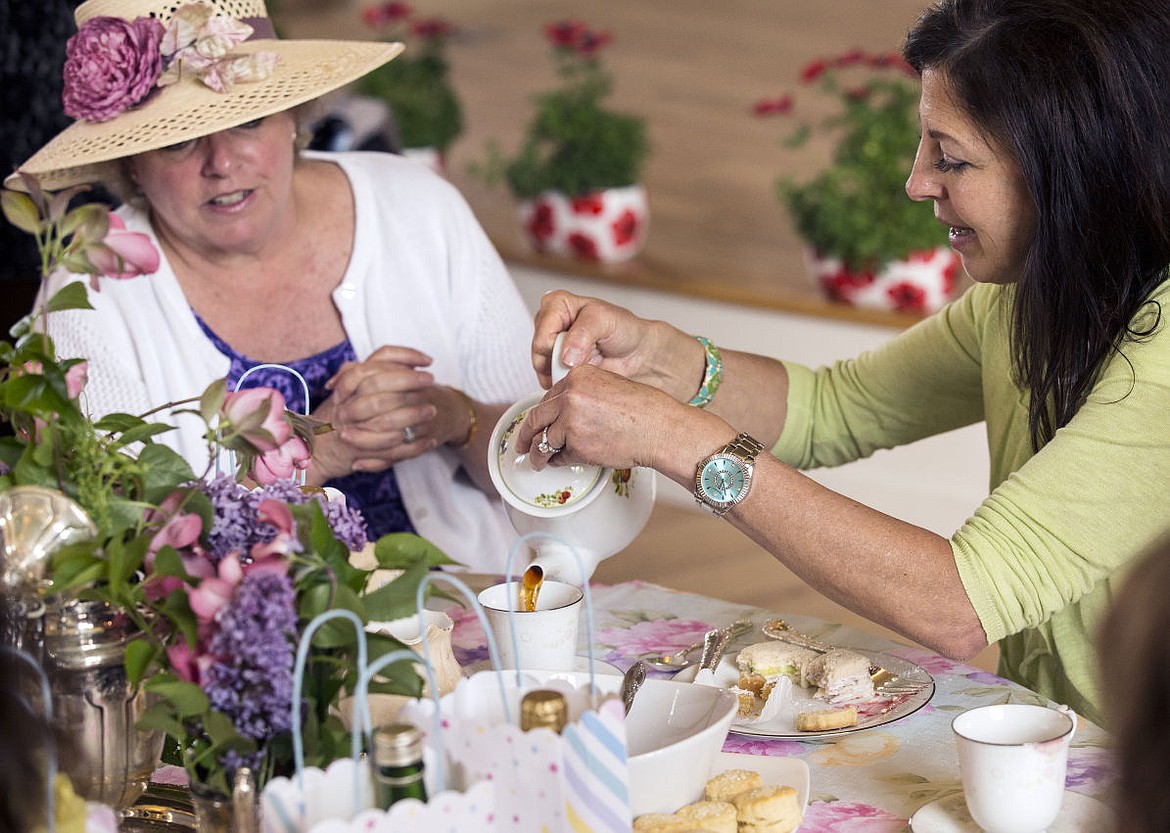 &lt;p&gt;Susan Jacobson, right, pours tea for Anne Hagman at the beginning of the &quot;May Day High Tea Party&quot; held in the Jacklin Arts and Cultural Center in Post Falls on Saturday.&lt;/p&gt;