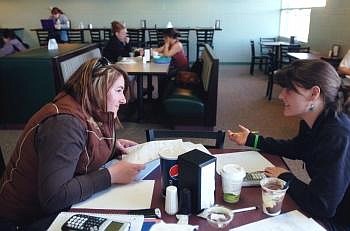 Tanya Turner, left, studies for a math class with J.J. Bessette in the Eagle's Nest Cafe at Flathead Valley Community College. Bessette is pursuing a degree in elementary education. The college board decided Friday not to increase basic tuition next year. Nate Chute/Daily Inter Lake