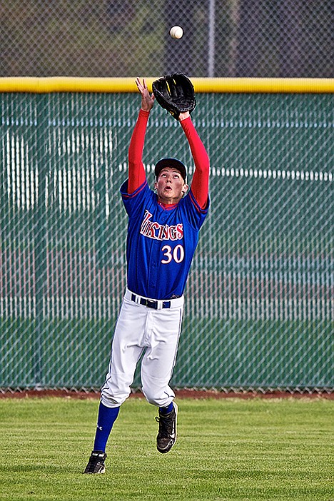 <p>Centerfielder Devin Kluss from Coeur d'Alene High follows the ball into his glove during the sixth inning.</p>