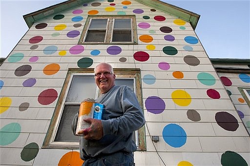 &lt;p&gt;In this photo taken Monday, April 30, 2012, Jim Deitz poses with a grin and a can of paint in front of his house in north Grand Forks, N.D. The retired house painter on Tuesday was putting the final polka dots on his home-turned-apartments, where passers-by have been gathering to watch him work and to request colors from his palette of a dozen cans of brightly colored paint. (AP Photo/Grand Forks Herald, Eric Hylden)&lt;/p&gt;