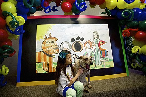 &lt;p&gt;Natasha DiBiase sits with her dog Satchmo following a presentation Wednesday at Lake City Junior Academy in Coeur d'Alene where the artwork she created for the &quot;Doodle 4 Google&quot; competition was unveiled. DiBiase's &quot;Becoming a Veternarian&quot; doodle is the state finalist for the competition which had more than 130,000 entries nationwide.&lt;/p&gt;