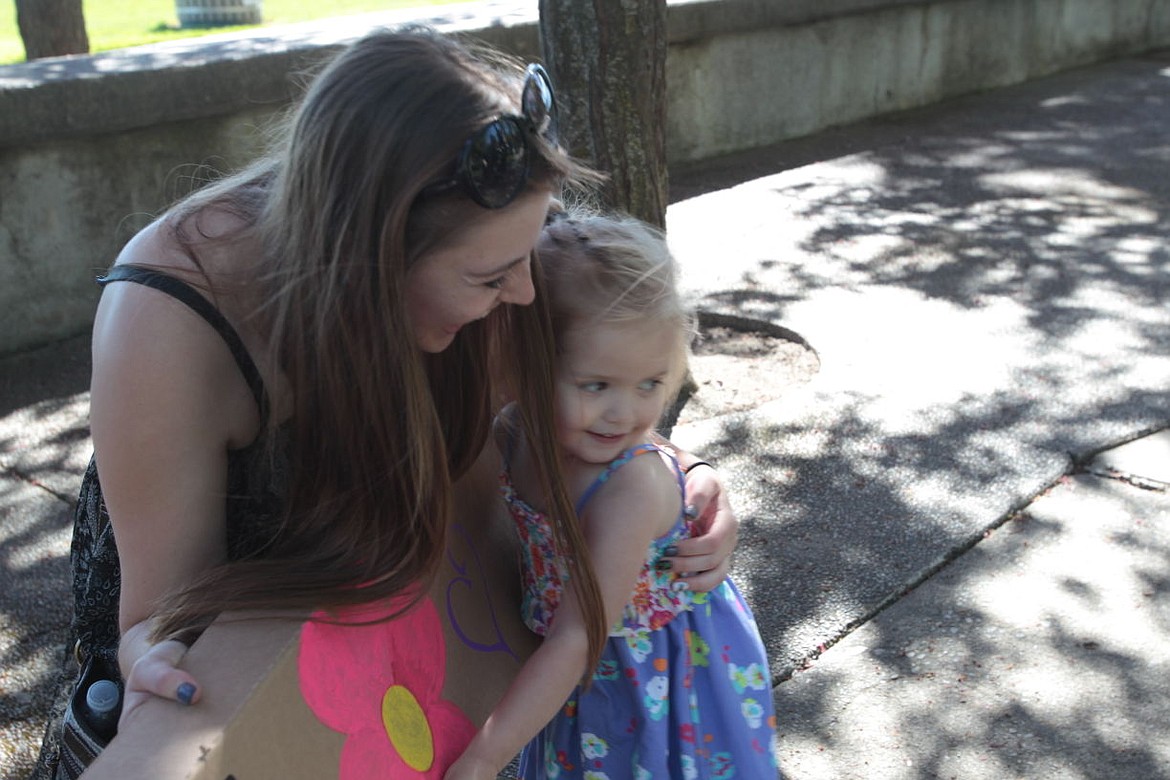 &lt;p&gt;North Idaho College student Mallory Gregson receives a hug from Addie Denke of Post Falls on Sunday. Several NIC students took to the streets of downtown Coeur d'Alene to spread the message of love in celebration of &quot;Global Love Day,&quot; as well as Coeur d'Alene's &quot;Choose Love Over Fear&quot; day.&lt;/p&gt;