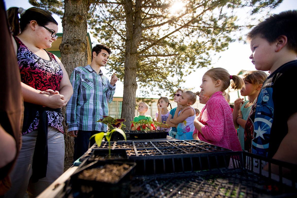 &lt;p&gt;Mullan Trail Elementary School second graders listen to New Visions High School student Seth Pullam explains on Monday the process of growing plants in a greenhouse, from seedling to full maturity. The high school is selling plants to the public this Saturday for one dollar per plant in order to raise funds for the school's greenhouse project.&lt;/p&gt;