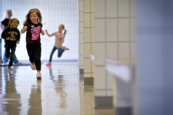 &lt;p&gt;JEROME A. POLLOS/Press Makenzee Thompson, 6, runs down the hallway with her classmates at Mullan Trail Elementary during the Mighty Moose March fundraiser Tuesday. Students raised fund by collecting pledges for each lap they completed. The funds will be used for classroom materials and instructional aides that will help maintain programs at the Post Falls school despite budget cuts.&lt;/p&gt;