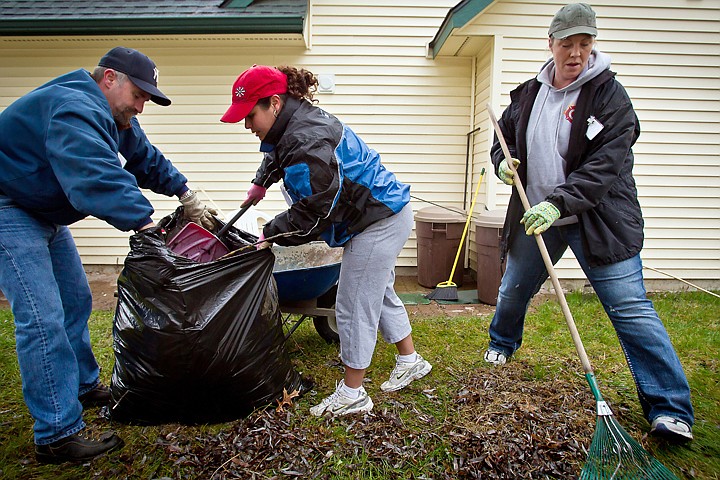 &lt;p&gt;JEROME A. POLLOS/Press Bret Bloodgood and Belinda Schrankel load a pile of leaves into a bag as Jodie Lynch rakes together another pile Wednesday during the &quot;Rake and Run&quot; volunteer event put on by CareNet, an organization made up of North Idaho senior service providers. Five teams tended to the yards of 13 senior citizens in Coeur d'Alene, Post Falls and Rathdrum helping clear debris, rake leaves, pull weeds and mow lawns.&lt;/p&gt;