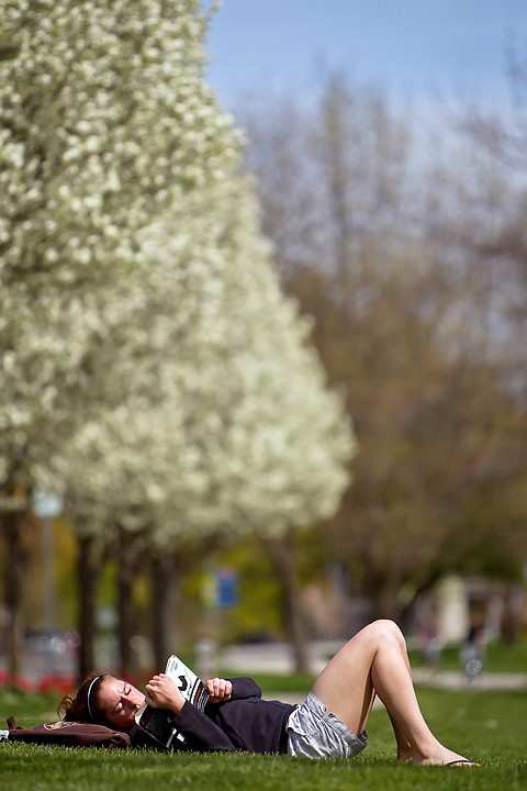 &lt;p&gt;JEROME A. POLLOS/Press Grace Bothfeld enjoys a book and some sunshine Monday while relaxing on the grass at McEuen Field in downtown Coeur d'Alene.&lt;/p&gt;