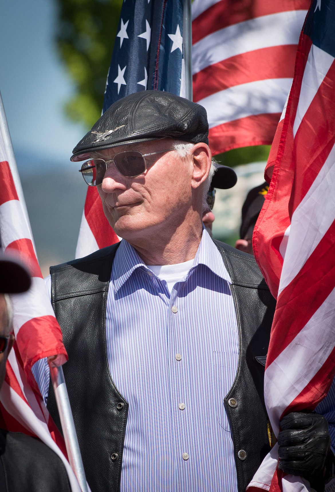 <p>Post Falls resident Tom Lien shows his support at Newby-ginnings' grand opening with flags. Lien is director of the Post Falls Urban Renewal Agency and a Vietnam veteran.</p>