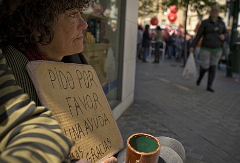 &lt;p&gt;Alice, a homeless woman, left, begs for alms, as people protest against the government's tough new labor reforms and cutbacks in Pamplona, northern Spain, Tuesday, May 1, 2012. Banging drums and waving flags, tens of thousands of workers marked May Day in European cities Tuesday with a mix of anger and gloom over austerity measures imposed by leaders trying to contain the eurozone's intractable debt crisis. (AP Photo/Alvaro Barrientos)&lt;/p&gt;