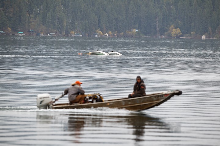 &lt;p&gt;SHAWN GUST/Press Two workers responsible for rescuing a flight instructor and a student of a plane that crashed into Hayden Lake during a lesson motors past the scene.&lt;/p&gt;