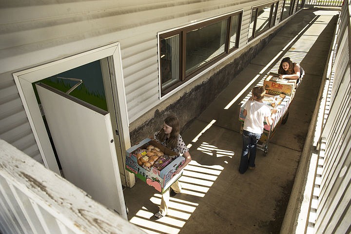 &lt;p&gt;LOREN BENOIT/Press From left to right, Borah Elementary fifth graders Naomi Fraley, Athena Williams and Ashlynn Wild bring food into the Coeur d'Alene Assembly Church Food Pantry on Wednesday, April 6, 2016. The Pantry, which opened the day after, is stocked with bread, dairy, fruits and other essential food products for families in need within the community.&lt;/p&gt;